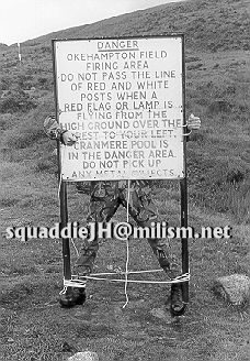 sqauddie John tied to a Dartmoor range warning board